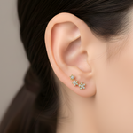 A model wears the 3-Star Diamond Stud earring, featuring three gold and diamond stars that climb up the earlobe.