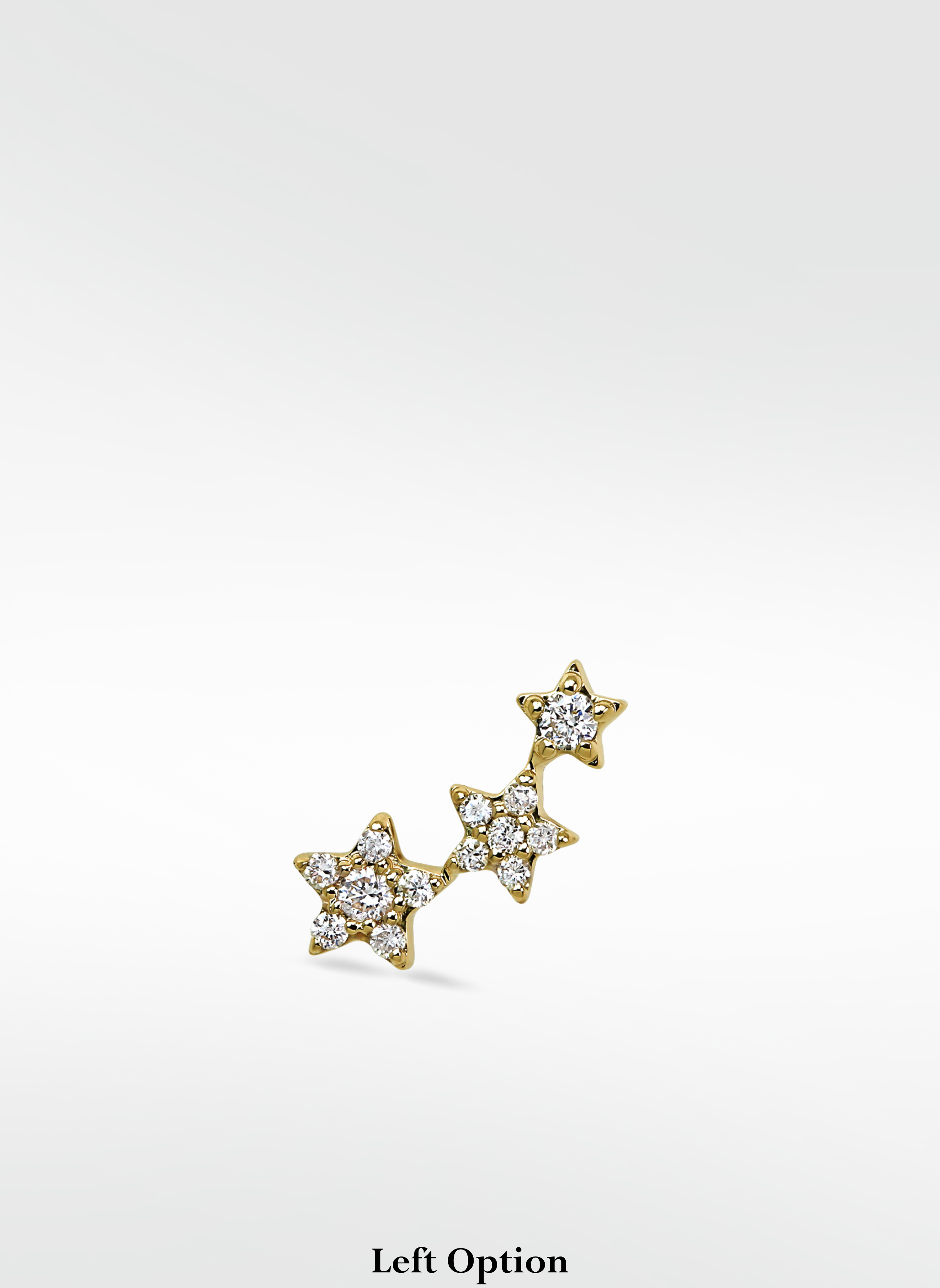 Lark & Berry's 3-Star Diamond Stud earring in a curved cluster, with pavé diamonds in yellow gold. Left ear option.