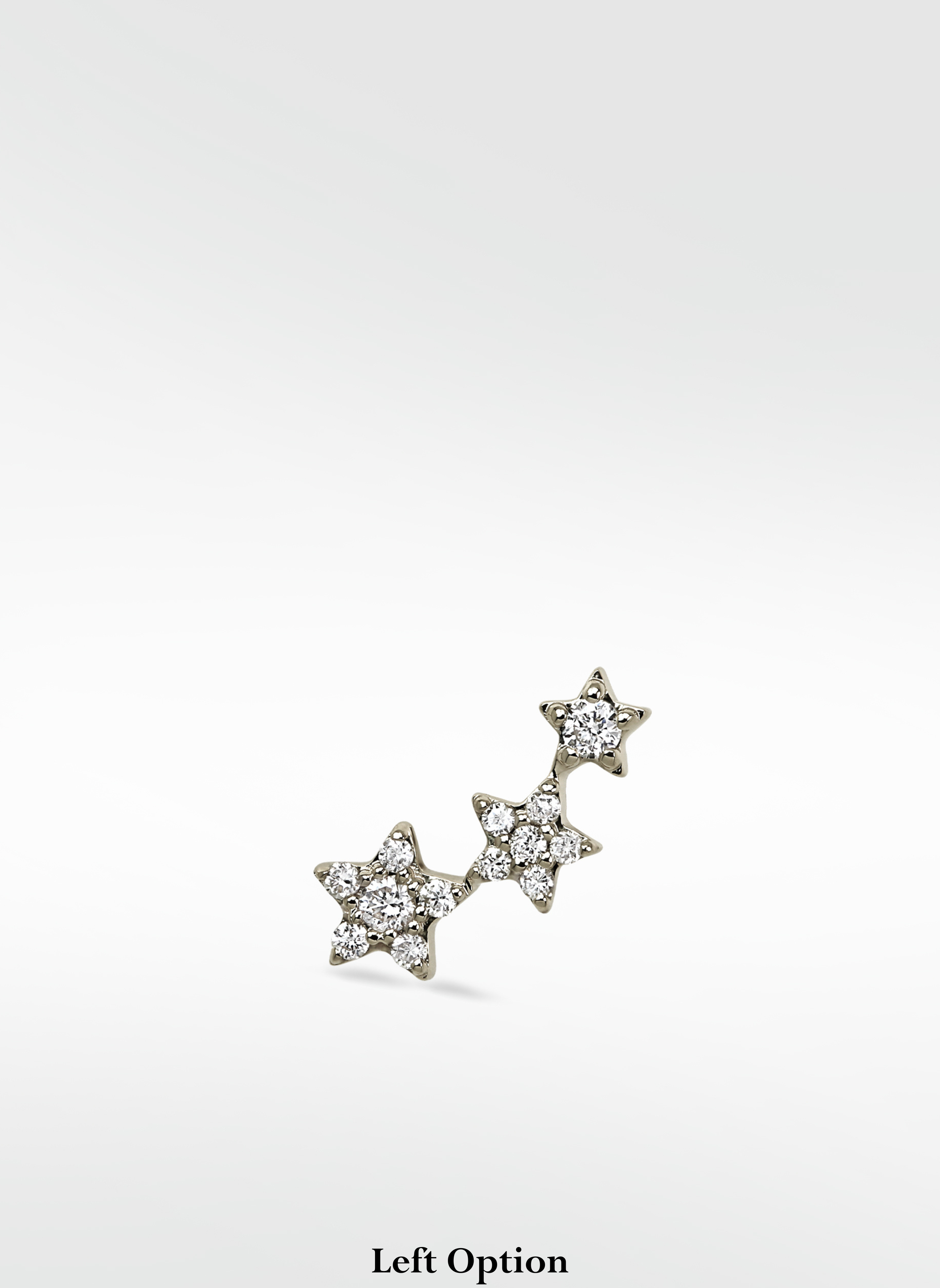 Left ear option of the 3-Star Diamond Stud, featuring a rising cluster of three stars paved with brilliant round diamonds.