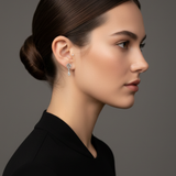 Model in profile wearing the Lark & Berry Celestial Swirl Diamond Stud earring with a dangling drop-shaped diamond.