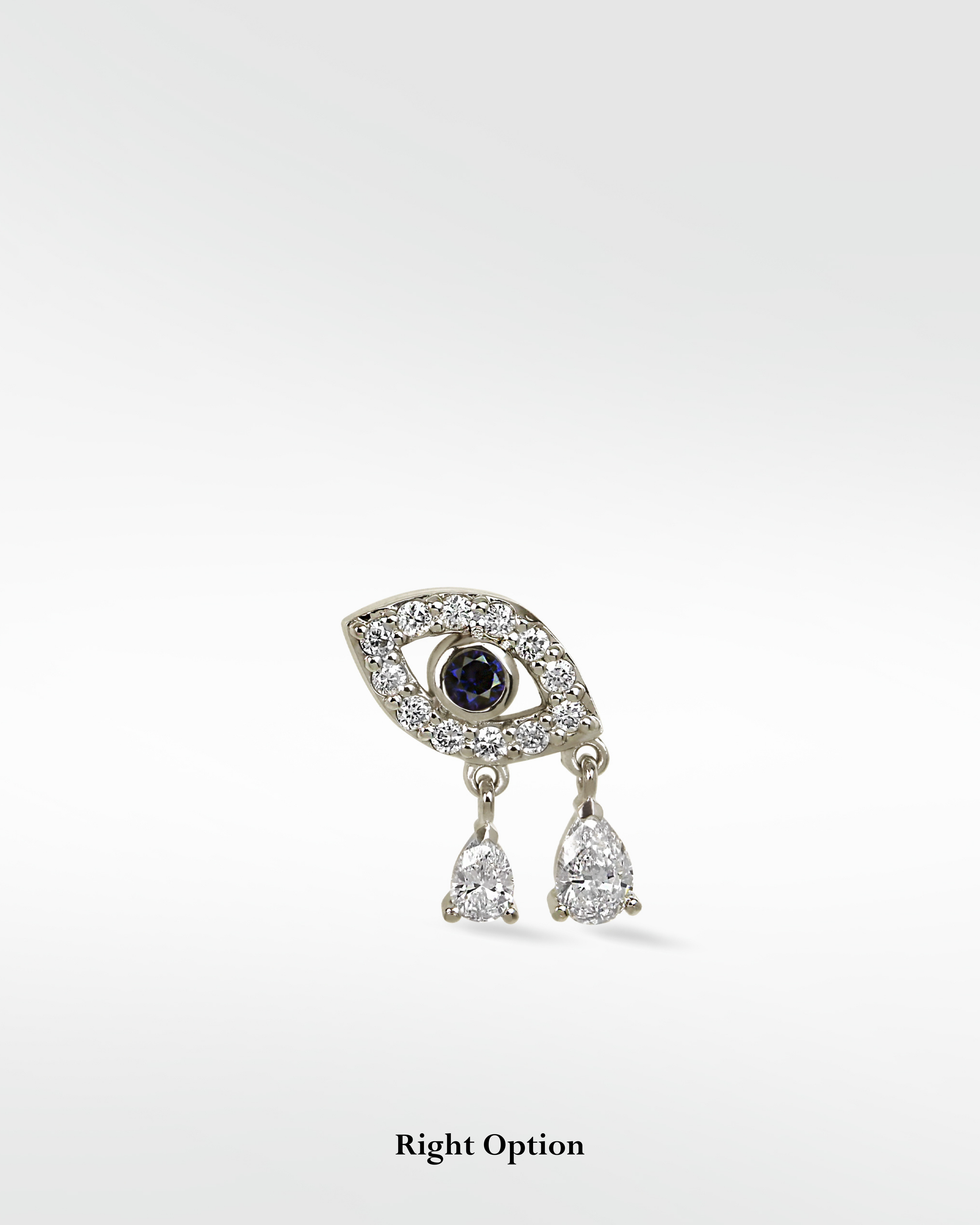 14k gold Evil Eye earring with a sapphire center, pavé diamonds, and two dangling pear-shaped diamond drops.