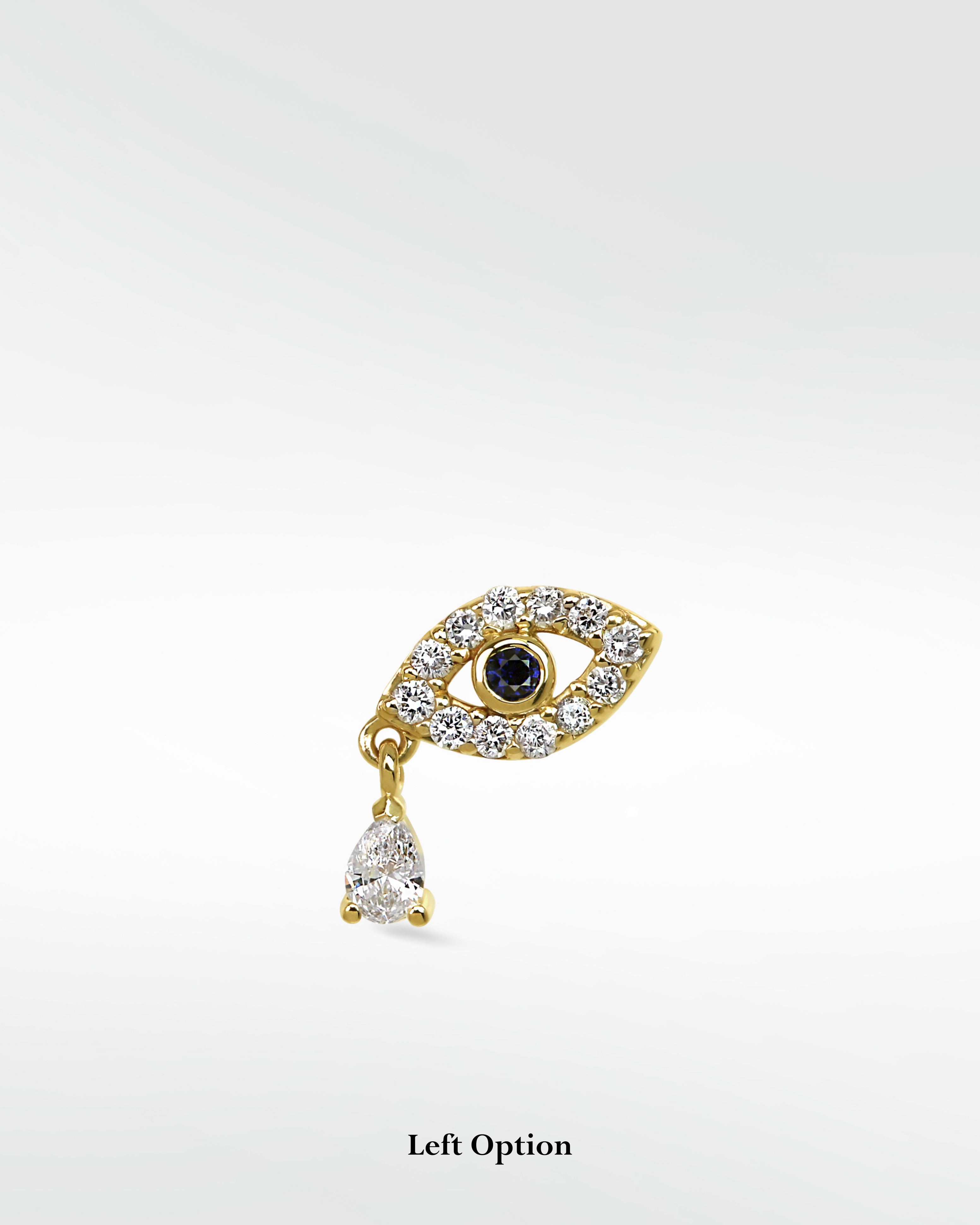 14k gold evil eye earring with pave diamonds, a blue sapphire center, and a pear-cut diamond drop.