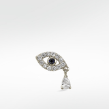 Right option of an evil eye earring in 14k white gold, with a blue sapphire pupil, pavé diamonds, and a dangling pear diamond.
