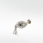14k white gold evil eye stud earring with a blue sapphire, pavé diamonds, and a dangling pear-shaped diamond.