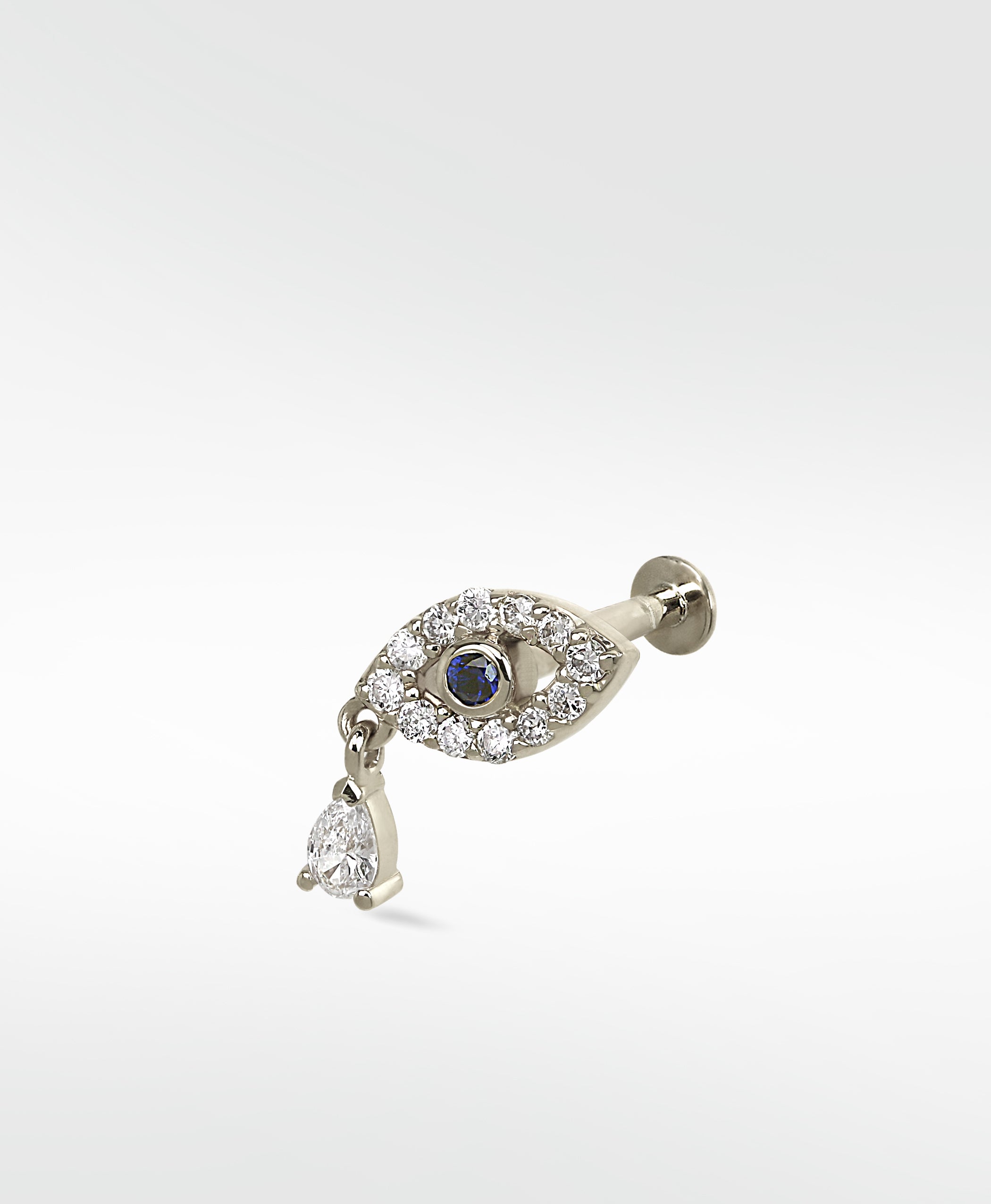 14k white gold evil eye stud earring with a blue sapphire, pavé diamonds, and a dangling pear-shaped diamond.