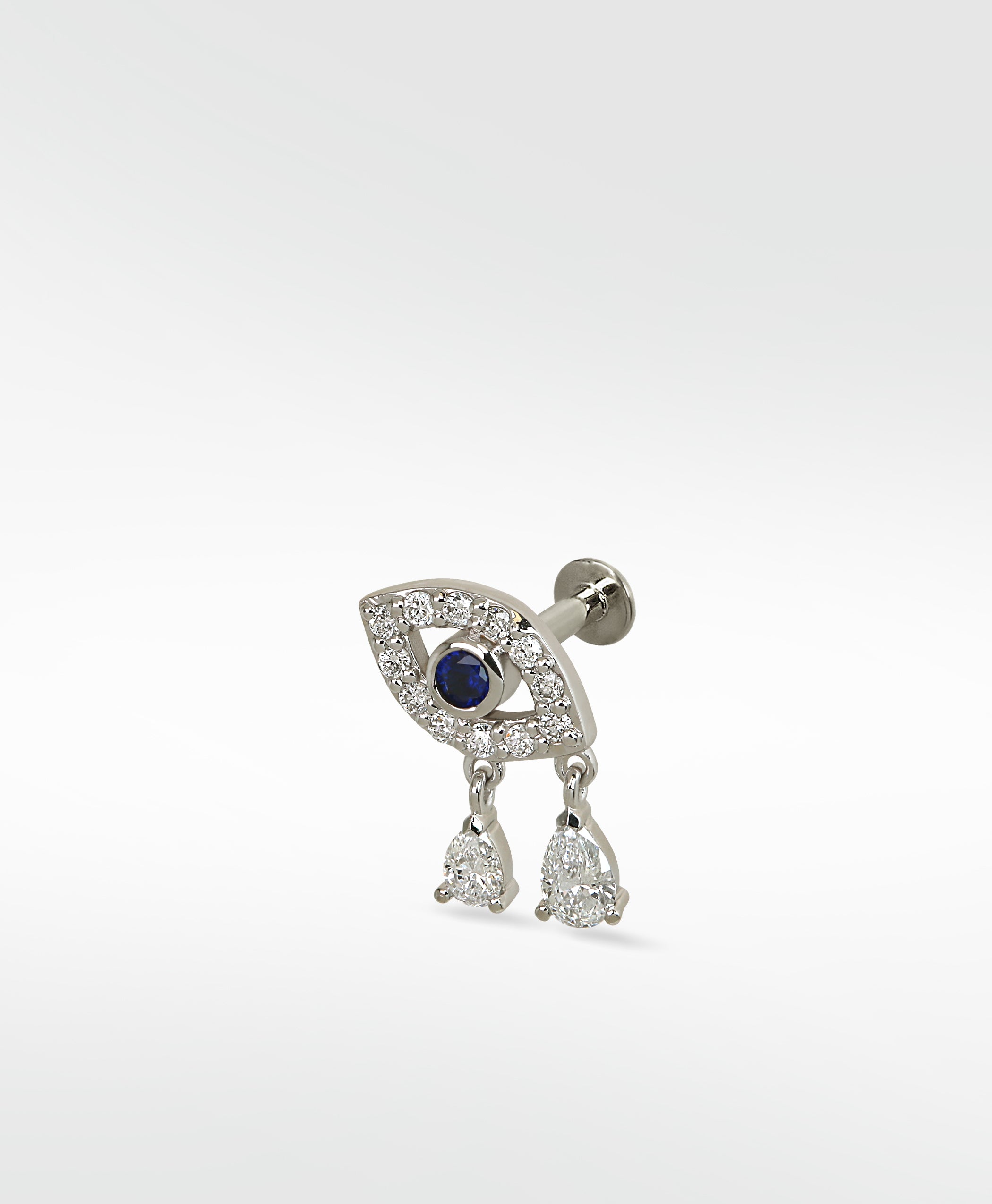 14k white gold evil eye stud with a blue sapphire, pavé diamonds, and two pear-shaped diamond drops.