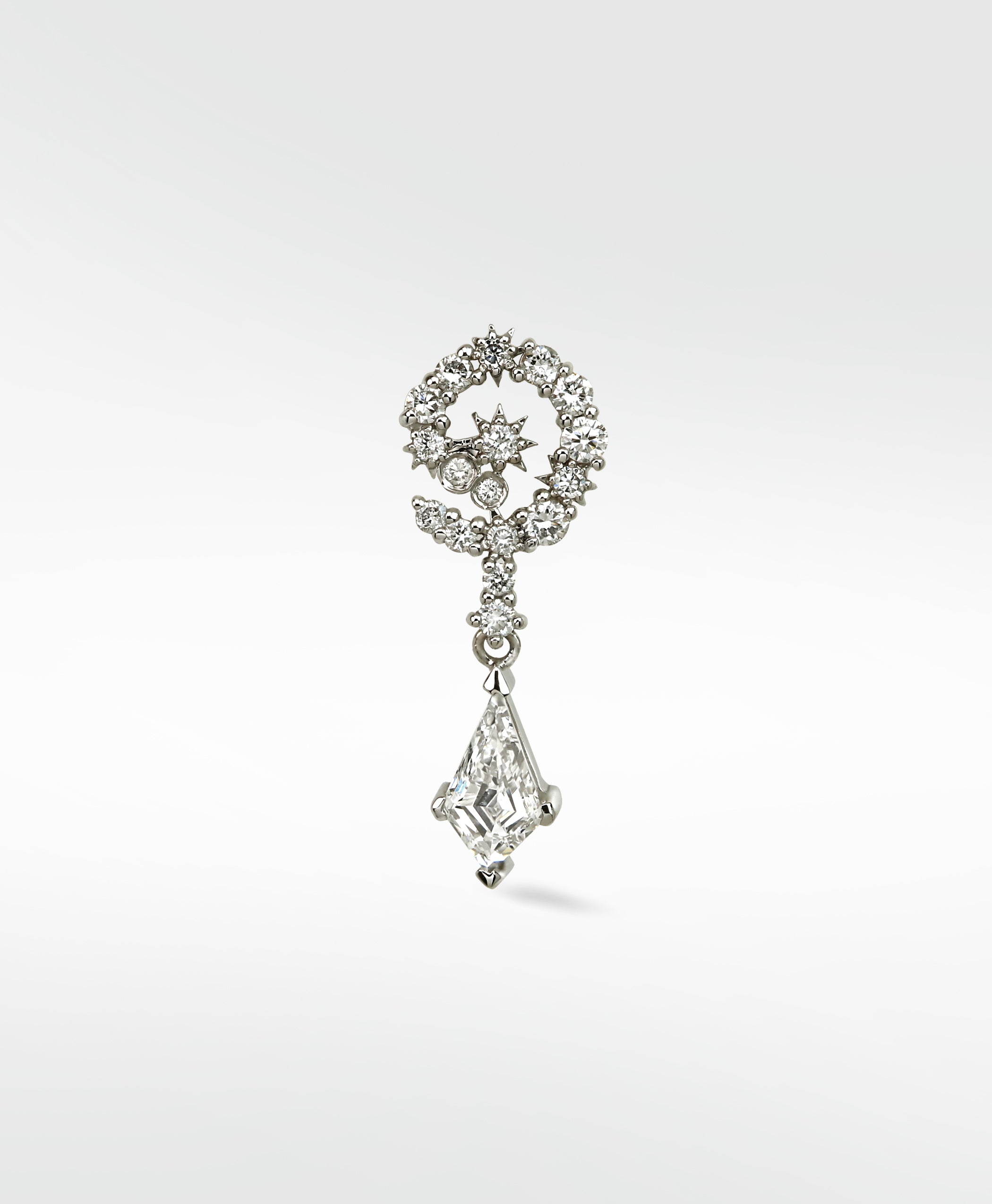 A 14k white gold Celestial Swirl Diamond Stud with a pavé crescent, star detail, and a dangling kite-shaped diamond drop.