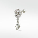 Celestial Swirl diamond stud in 14k white gold with a pavé swirl top and a dangling kite-shaped diamond.