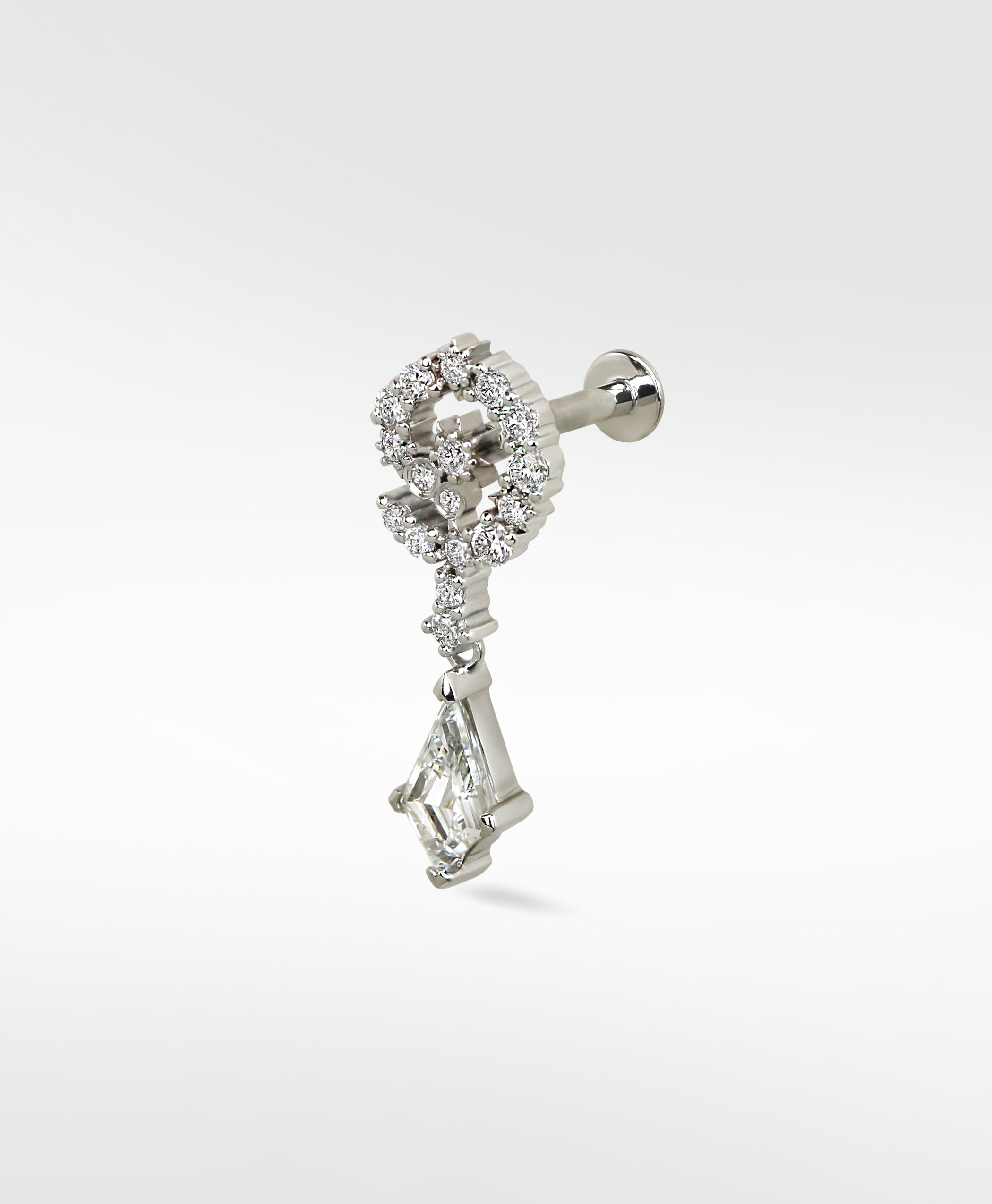 Celestial Swirl diamond stud in 14k white gold with a pavé swirl top and a dangling kite-shaped diamond.