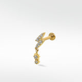 A gold lightning bolt labret stud earring paved with diamonds, featuring a dangling diamond drop charm on a white background.