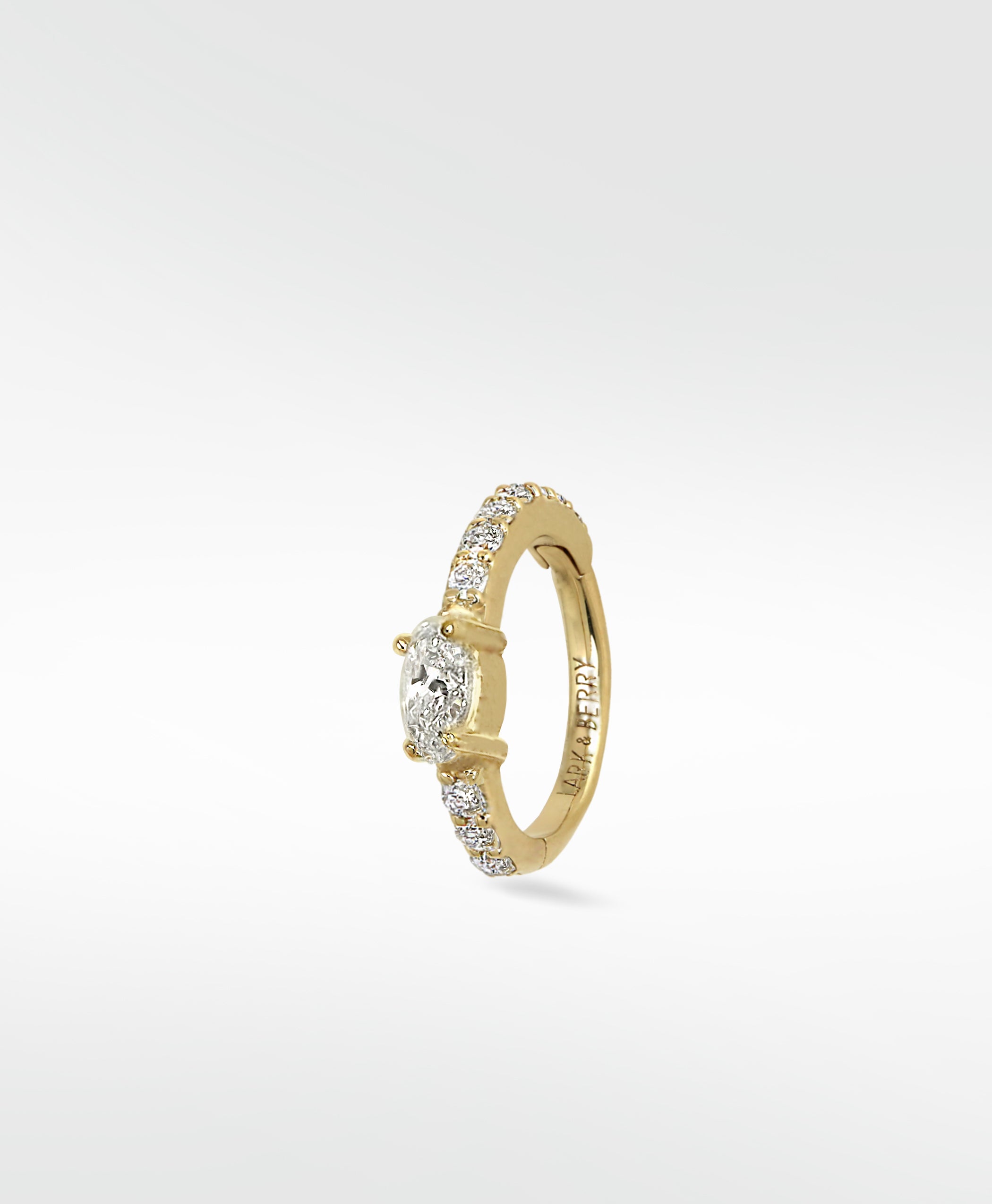 Lark & Berry Modernist Oval Diamond Hoop in yellow gold with pavé diamonds, shown at a slight angle on a white background.