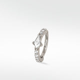 Modernist Kite Diamond Hoop earring in 14k white gold with a central kite-cut diamond and brilliant cut pavé diamonds.