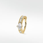 A yellow gold Modernist hoop earring featuring a central triangle diamond and channel-set baguette diamonds on a white background.