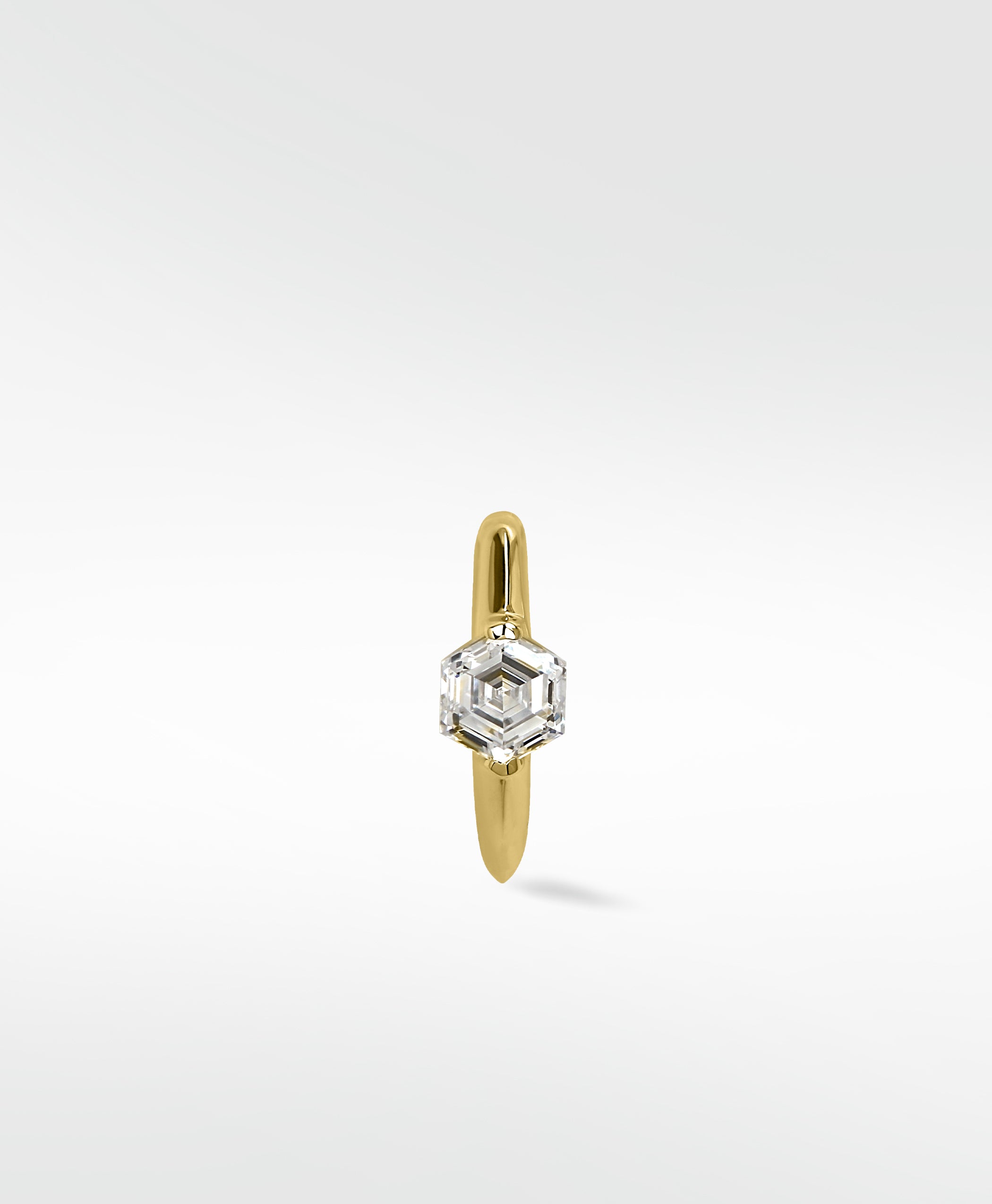 A single 14k yellow gold knife-edged hoop earring featuring a bezel-set hexagonal diamond, shown on a white background.