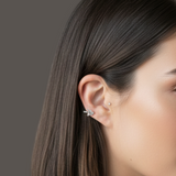 Close-up of a model wearing the Firework Diamond Stud earring, featuring a cluster of baguette and round diamonds on the earlobe.