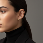 A model's ear styled with Lark & Berry's 3-Star Diamond Stud, a single diamond stud, and a gold hoop earring.