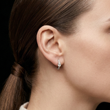 Profile view of a model wearing the elegant Lark & Berry Modernist Oval Diamond Hoop, featuring a central oval diamond.